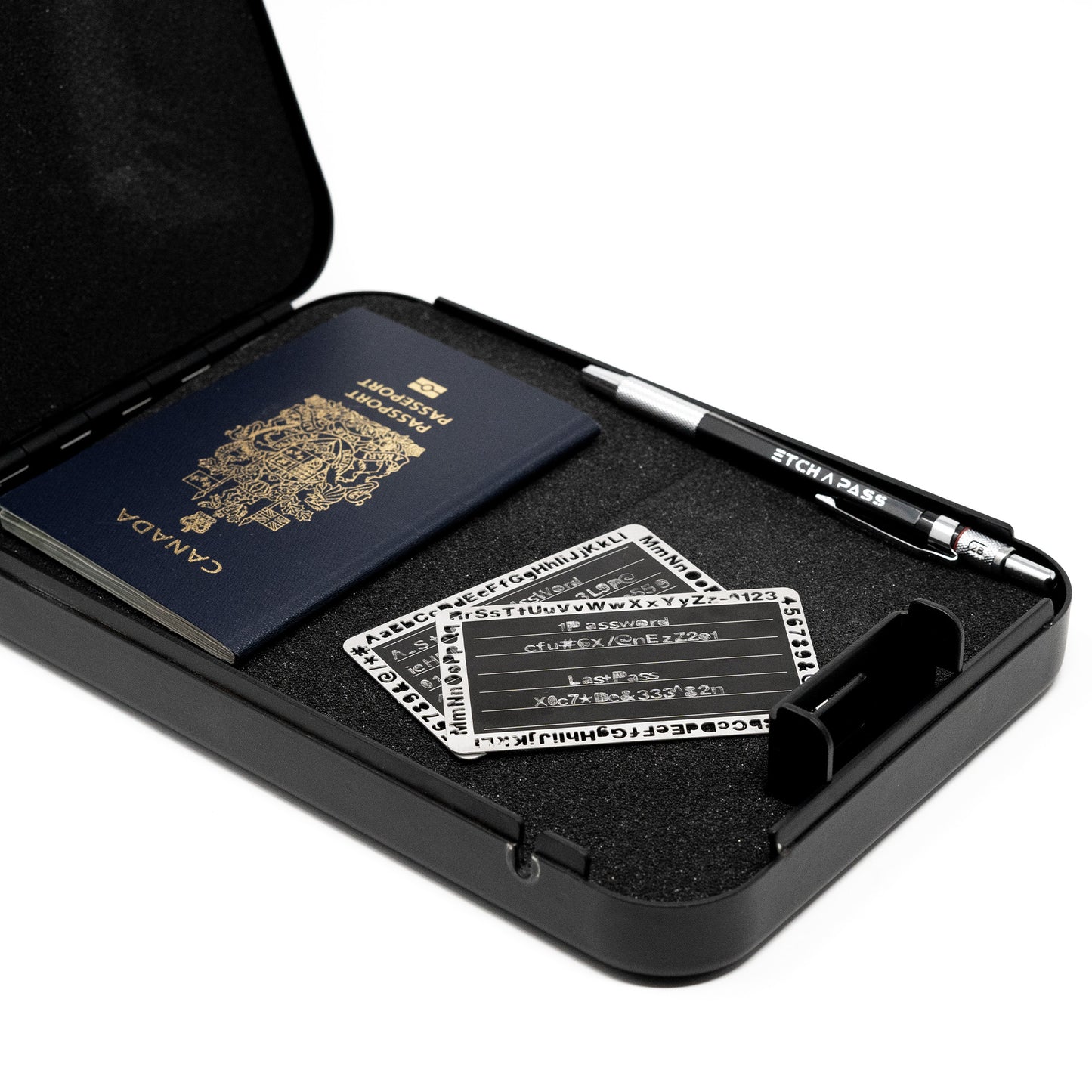 EtchPass kit with stainless steel cards, engraving pen, and a secure storage case alongside a passport.