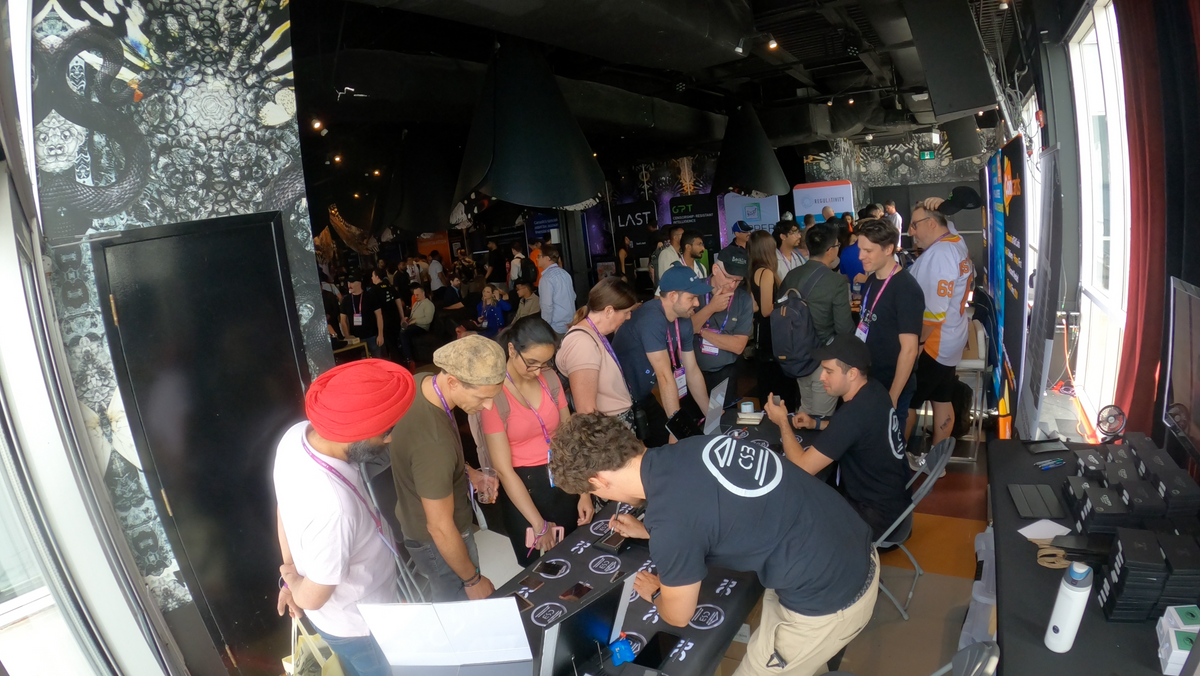 Visitors watching a hands-on Crypto Seed Bank™ engraving demonstration at the Blockchain Futurist Conference.