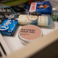 Natural Hair Gel tin discreetly placed in a drawer among toiletries, showcasing its use as a hidden storage for securing crypto hardware wallets.