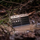 Crypto Seed Bank® stainless steel card submerged in muddy water.